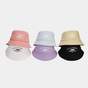Detailed display of assorted colorful cotton bucket hats with stylish letter embroidery