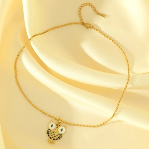 Gold owl pendant necklace with colorful zircons and seed bead chain on silk background