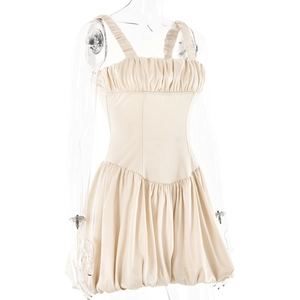Detail of beige square neck mini dress featuring ruffled bust and glossy flared hemline