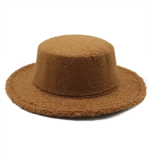 Detail of caramel sherpa flat top wide brim hat showing warm textured lamb wool fabric