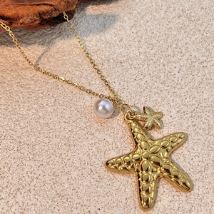 Gold starfish pendant necklace with pearl charm on minimalist chain for women
