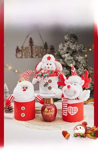 Detailed view of knitted Santa, Snowman, and Reindeer Christmas gift bags for treats