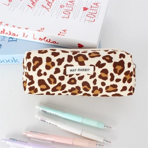 Close-up of leopard print corduroy pencil case with white zipper and brand label