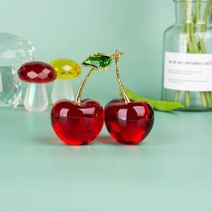 Vibrant red crystal cherry figurine tabletop decoration with gold stem and green leaf