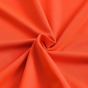 Detailed macro view of orange ribbed knit fabric texture with soft twisted folds