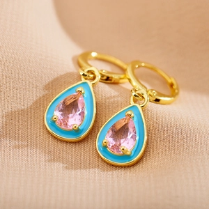 Detailed macro view of pear-cut pink zircon earrings with sky blue enamel and gold finish