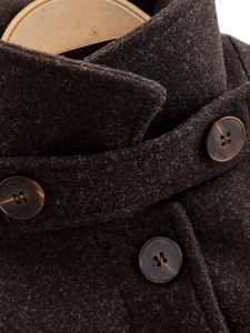 Close-up of lapel detail and marble-textured resin buttons on dark coffee wool coat