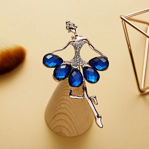 Macro detail of ballerina brooch with gold plating and blue pear-cut crystals