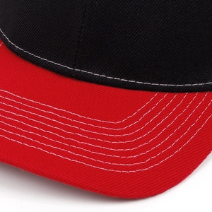 Street style mesh trucker hat featuring black crown with red brim and white stitching