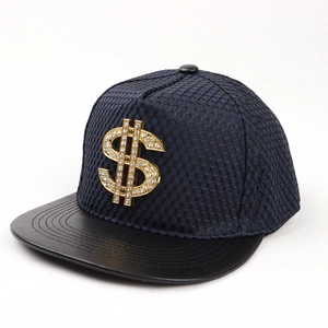 Detail of blue mesh snapback hat with gold rhinestone dollar sign emblem and black leather brim