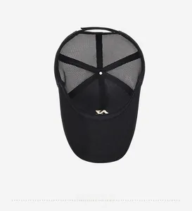Close-up of black mesh baseball cap interior with gold logo and reinforced stitching