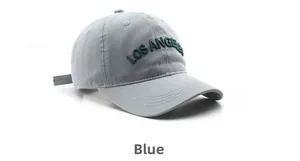 Close-up of Los Angeles 3D embroidery on breathable blue cotton baseball cap