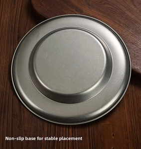 Detail of the non-slip bottom on a vintage stainless steel plate for stable placement