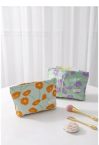 Detail of floral makeup bags with textured embossed fabric and decorative floral patterns