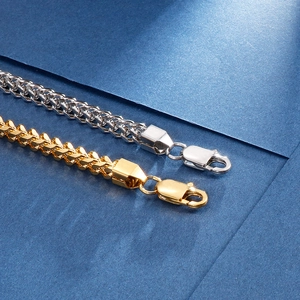 Detailed close-up of gold and silver stainless steel keel chains with lobster clasps
