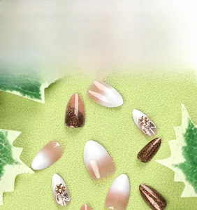 Detailed view of Christmas press-on nails with pink gradient and gold 3D flower designs