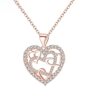 Detail view of interlocking heart pendant with rose gold finish and white crystals