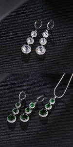 Detail of silver drop jewelry sets with white and emerald green cubic zirconia stones