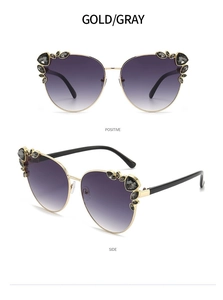 Detail view of gold cat-eye sunglasses with gradient lenses and rhinestone embellishments