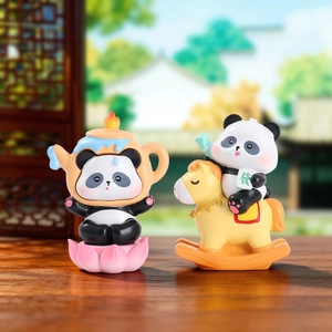 Detailed shot of panda figurines featuring a lotus teapot and a lucky mahjong rocking horse
