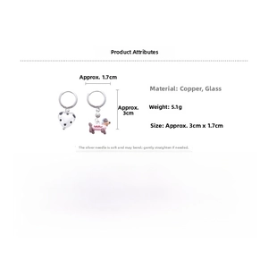 Detailed view of asymmetric dachshund earrings with white heart and pink dog charms