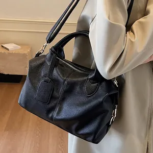 Classic black lychee pattern leather Boston bag with dual handles and crossbody strap