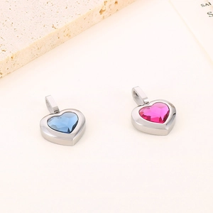 Close-up of heart-shaped titanium steel pendants with blue and pink crystal inlays