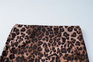 Detailed macro view of the slim-fit leopard print skirt waistline and fabric texture