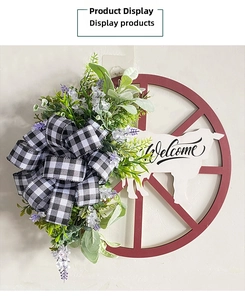 Detail of wooden wheel wreath with cow silhouette and black-white buffalo check bow