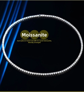 Detailed macro view of silver tennis necklace with hand-set 0.3 carat moissanite stones