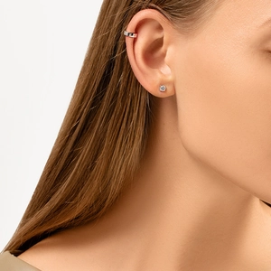 Close-up of S925 sterling silver geometric ear cuff and single stud earring on ear