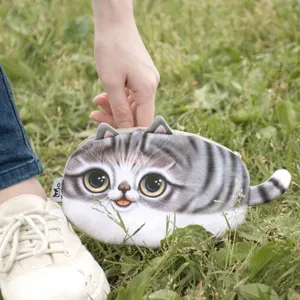 Detailed view of the 3D tabby cat plush pouch with a cute tail on green grass