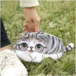 Detailed view of the 3D tabby cat plush pouch with a cute tail on green grass