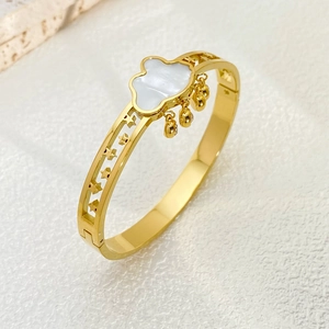 Golden stainless steel clover bangle with white mother of pearl inlay and star cutouts