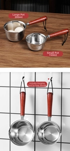 Detail of stainless steel oil pouring pots with dual pour spouts and wood handles