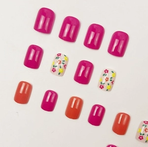 Short square press-on nails with deep rose, orange, and floral pattern designs