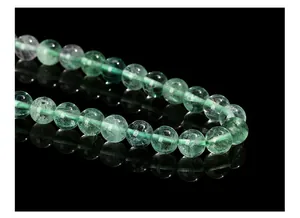 Macro detail of natural green fluorite beads showing internal ice cracks and textures