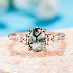 Rose gold ring with oval moss agate and marquise side stones on mineral base