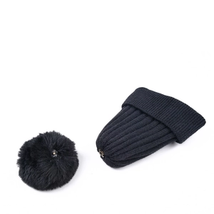 Black rib-knit beanie for children with a detachable faux fur pom-pom on white background