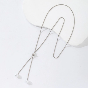 Close-up of adjustable silver snake chain necklace with elegant white pearl charms