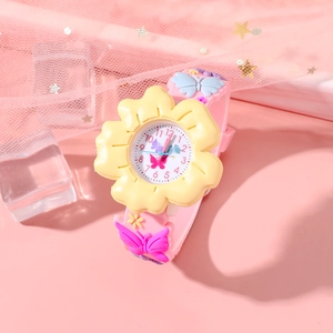 Detail of a cute pink and yellow floral watch with butterfly accents on a soft strap