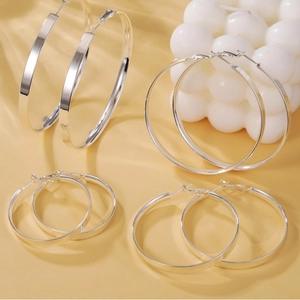 Set of four silver polished brass hoop earrings in various sizes for a modern look