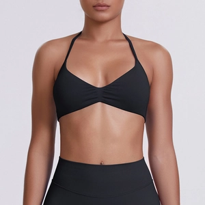 Front view of black halter neck sports bra with V-neckline and minimalist pleated details
