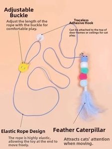 Detail of hanging cat toy featuring elastic rope, plush caterpillar and blue feather
