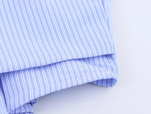 Detail shot of the blue and white vertical striped cotton fabric and stitching craft