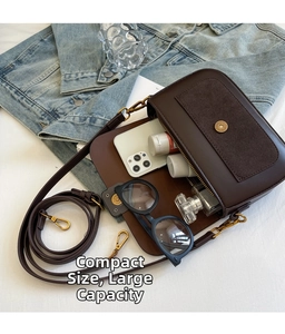 Detail view of the spacious interior of this dark brown vintage crossbody bag