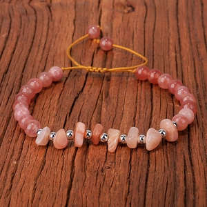 Detail of handmade woven bracelet with pink quartz chips and polished silver beads