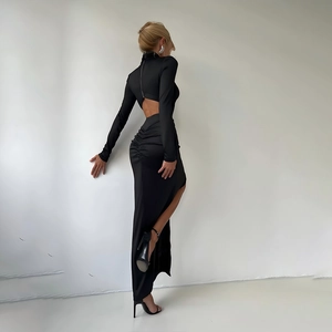 Detail of elegant backless design and zipper on this black long-sleeve evening dress