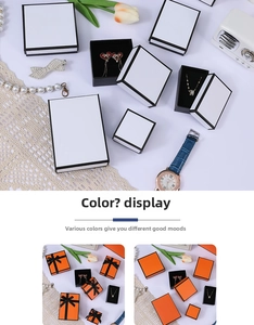 Macro shot of orange jewelry gift boxes with black ribbons for rings and necklaces