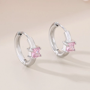 Detail of pink square-cut crystal earrings with a polished silver huggie closure